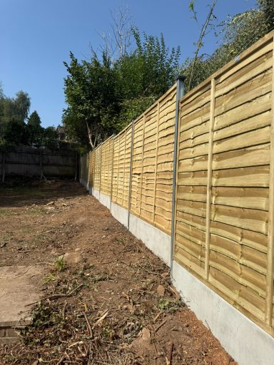 Panelled fencing with concrete gravel boards and posts.